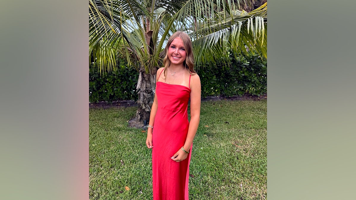 Elizabeth Angle smiling in a red dress