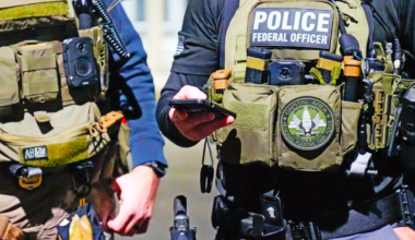 Picture of tactical uniforms of two ICE agents.