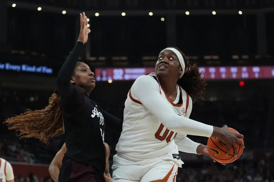 Texas center Kyla Oldacre (00) looks to shoot past Texas A&M center Emerald Parker (24) during the second half of an NCAA college basketball game in Austin, Texas, Sunday, Jan. 18, 2026. (AP Photo/Eric Gay)