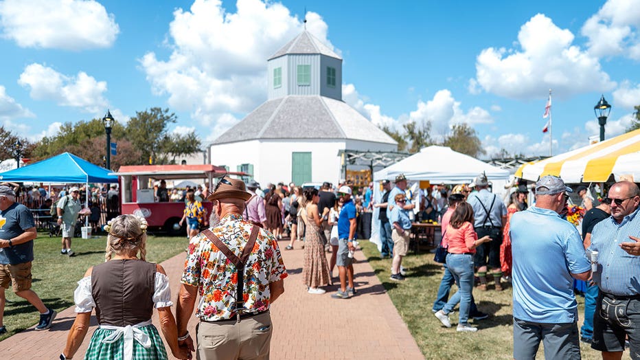 Attendees walk through the 45th Oktoberfest festival on Oct. 4, 2025 in Fredericksburg, Texas.