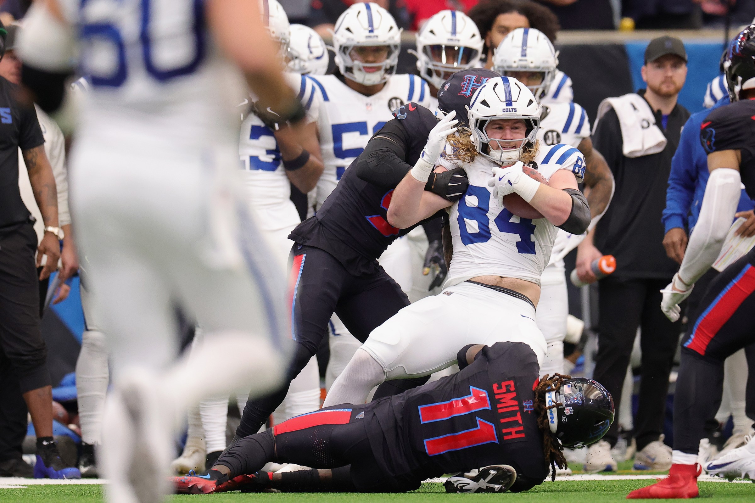 HOUSTON, TEXAS - JANUARY 04: Tyler Warren #84 of the Indianapolis Colts is stopped by Jalen Pitre #5 and Tremon Smith #11 of the Houston Texans during the first quarter of the game at NRG Stadium on January 04, 2026 in Houston, Texas. (Photo by Alex Slitz/Getty Images)