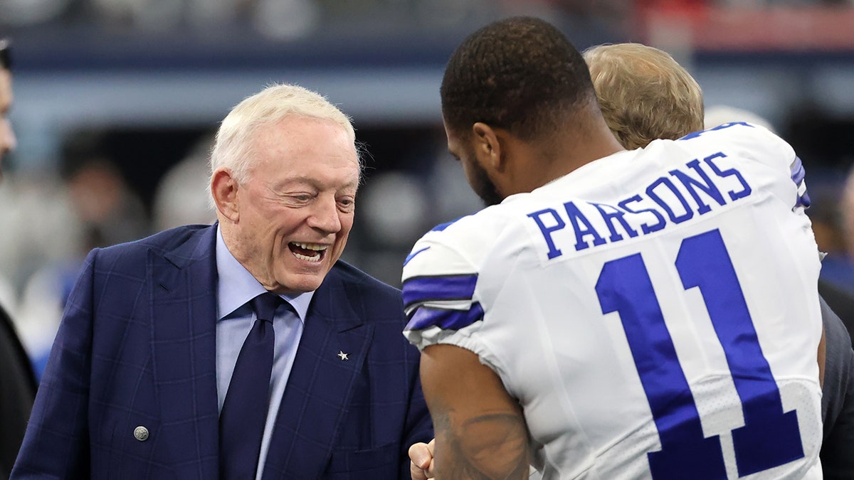 Micah Parsons and Jerry Jones greet each other