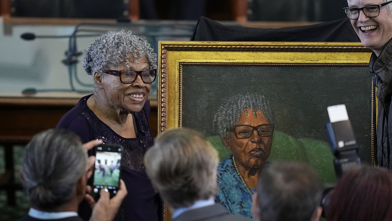 Opal Lee, left, who helped make Juneteenth a federally recognized holiday, poses with her portrait after it was unveiled in the Texas Senate Chamber, Wednesday, Feb. 8, 2023, in Austin, Texas. (AP Photo/Eric Gay)