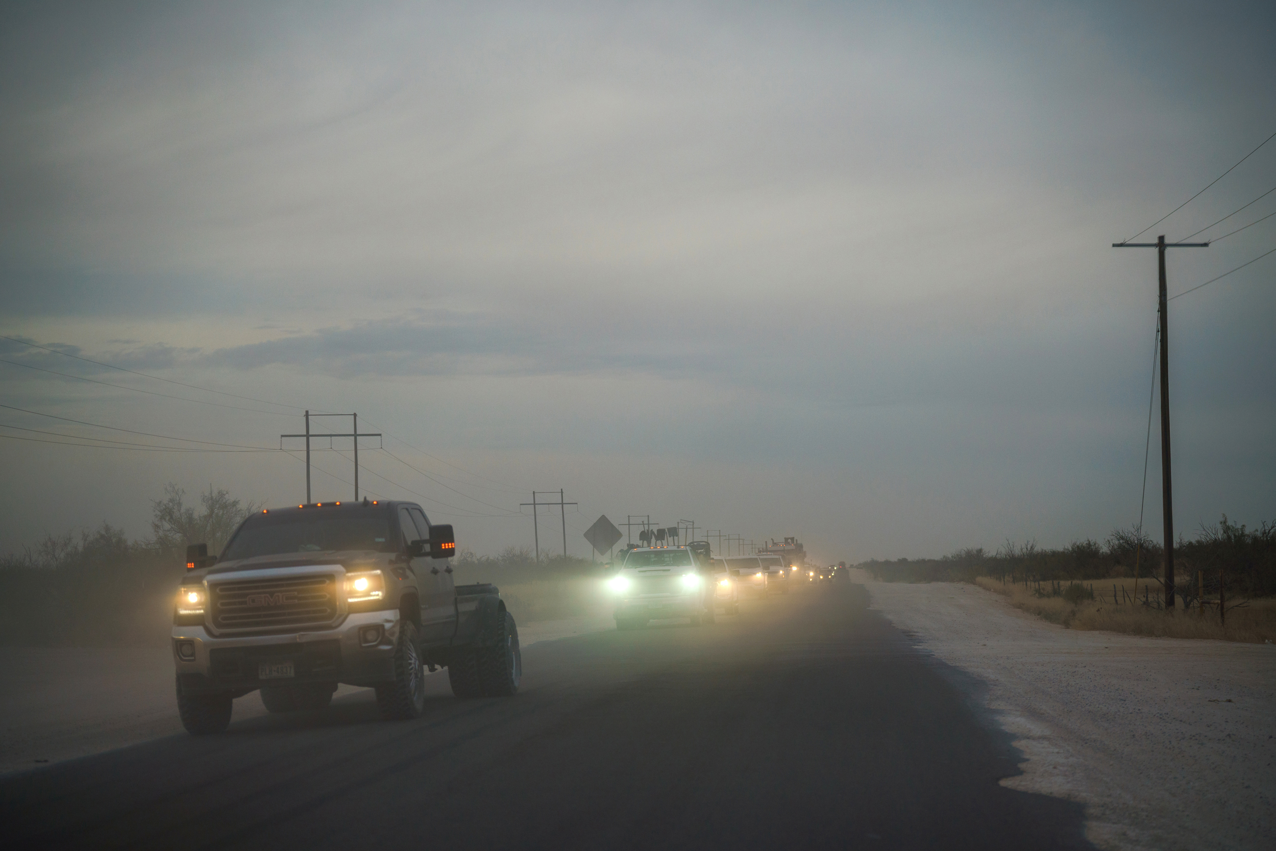 Trucks speed through the dust along Frying Pan Ranch Road near the City of Midland’s T-Bar Ranch in Winkler County, Texas. Credit: Paul Ratje/Inside Climate News