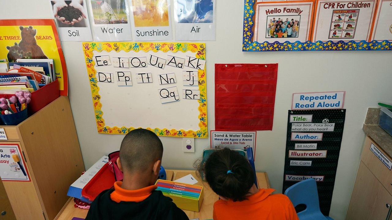 Students help put away supplies at the end of a reading and writing lesson at the Head Start program run by Easterseals, an organization that gets about a third of its funding from the federal government, Wednesday, Jan. 29, 2025, in Miami. (AP Photo/Rebecca Blackwell, File)