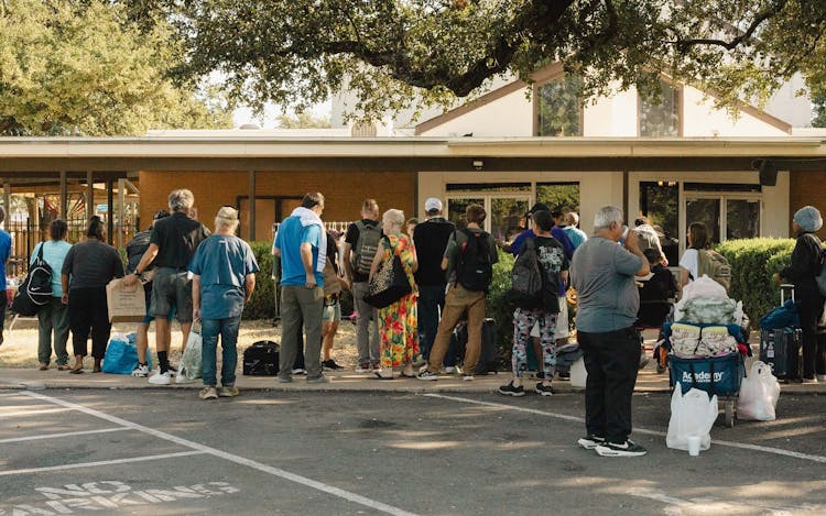 Men and women line up for breakfast at Sunrise Church, in Austin on September 3, 2025.