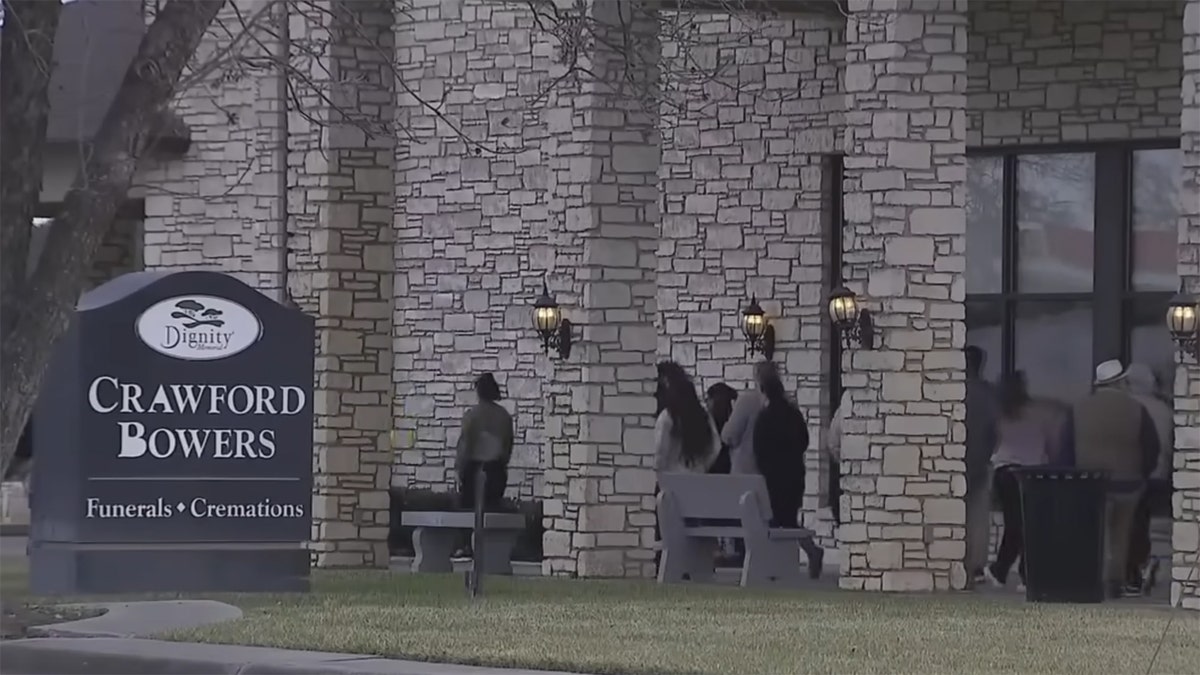 Mourners attend the funeral of fallen police officer Elijah Garrison