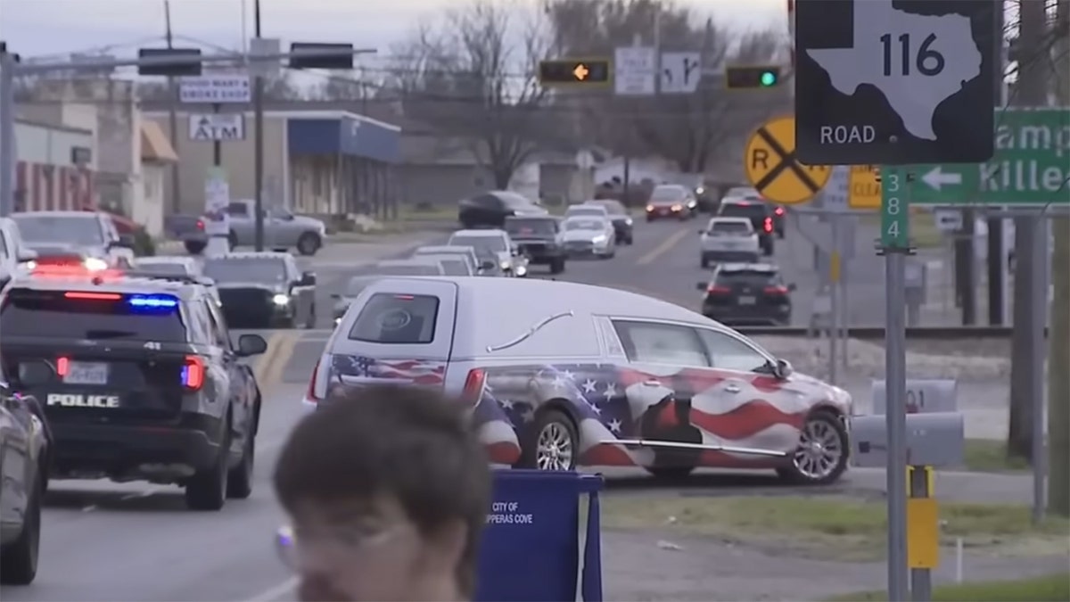 The body of fallen police officer Elijah Garrison is escorted to the the Crawford Bowers Funeral Home