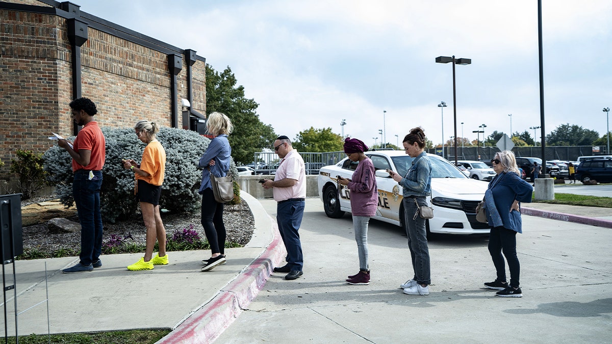 People wait their turn inside a voting site as Election Day gets underway.