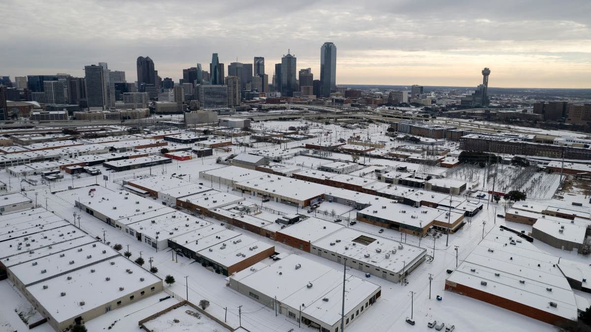 Aerial view of snow-covered buildings and streets in Dallas, Texas, during a winter storm.