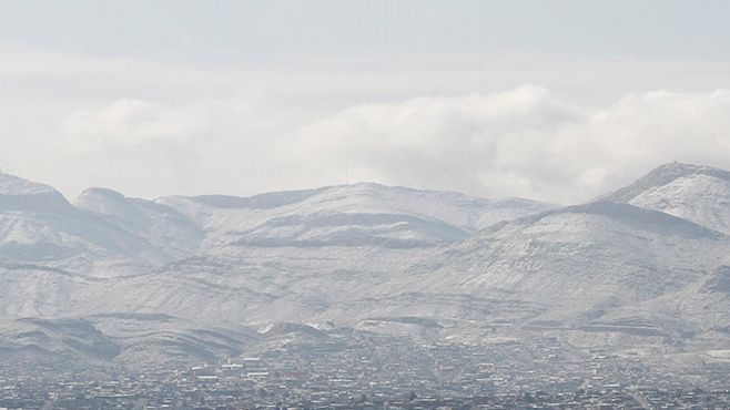 Snow obscures writing on the side of the mountains above Ciudad Juarez, Mexico, as seen from El Paso, Texas, on Wednesday, Feb. 5, 2020. A few inches of snow led to slow starts at schools in El Paso and caused hour-long delays on local roads. (AP Photo/Cedar Attanasio)