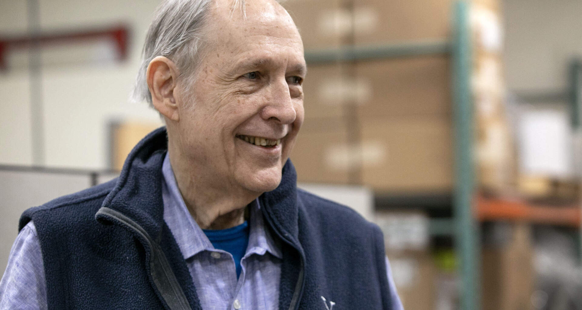 Roasted coffee beans pour out of a coffee roasting machine at the George Howell roastery in Acton, Mass. (Robin Lubbock/WBUR)