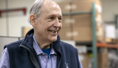 Roasted coffee beans pour out of a coffee roasting machine at the George Howell roastery in Acton, Mass. (Robin Lubbock/WBUR)