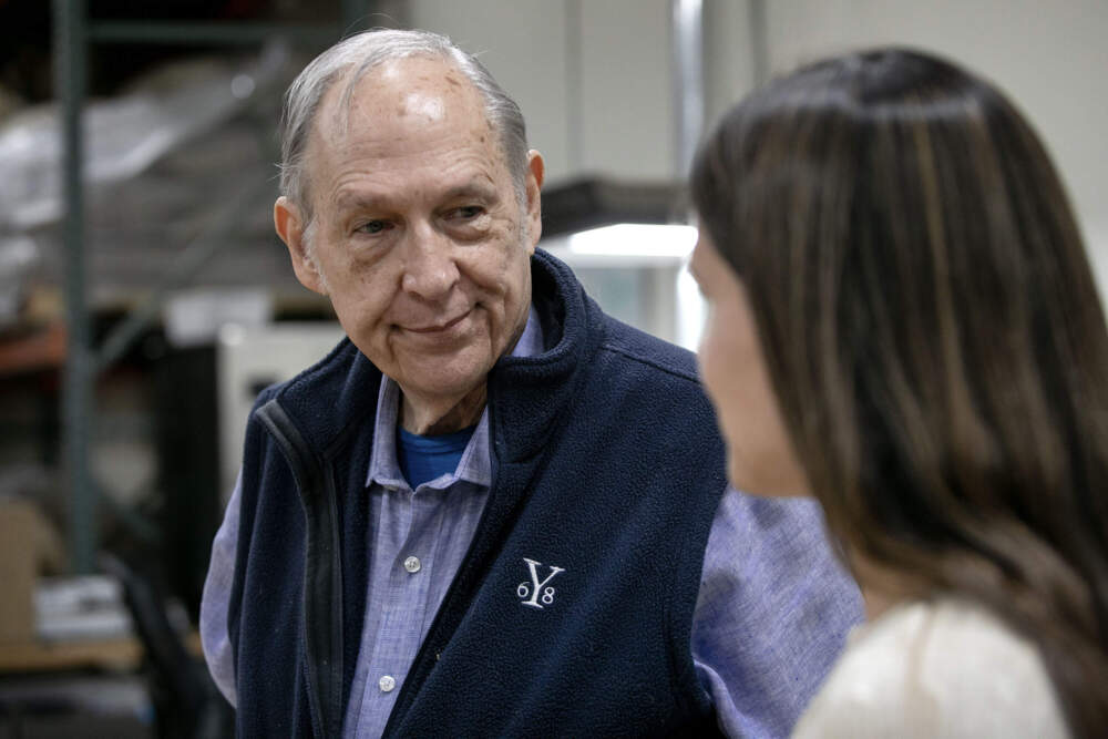 George Howell and his daughter Jennifer Howell discuss coffee samples at a cupping session at the roastery in Acton, Mass. (Robin Lubbock/WBUR)