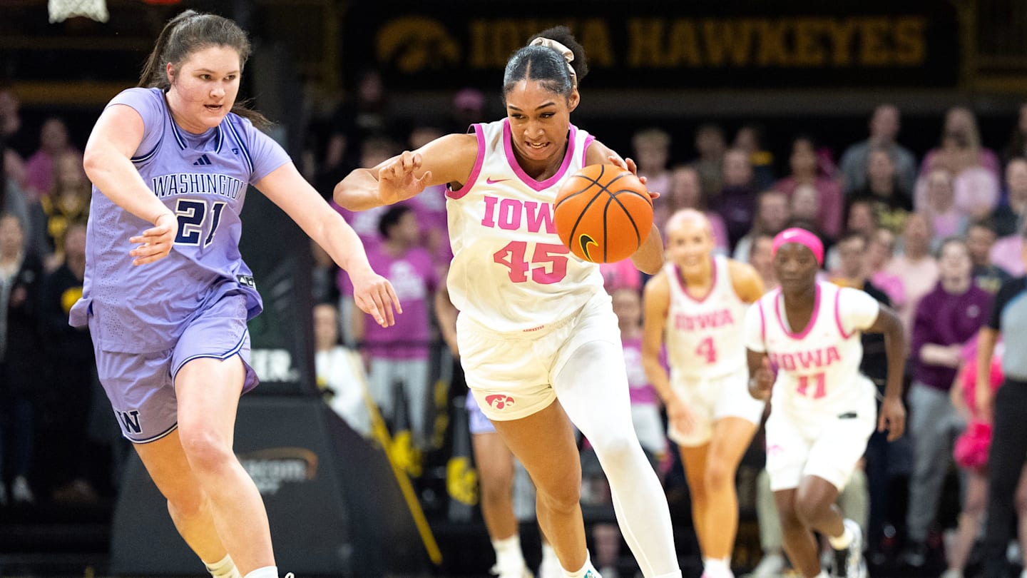 Washington forward Brynn McGaughy (21) trails Iowa forward Hannah Stuelke (45) as she drives down court Feb. 11, 2026 at Carver-Hawkeye Arena in Iowa City, Iowa.
