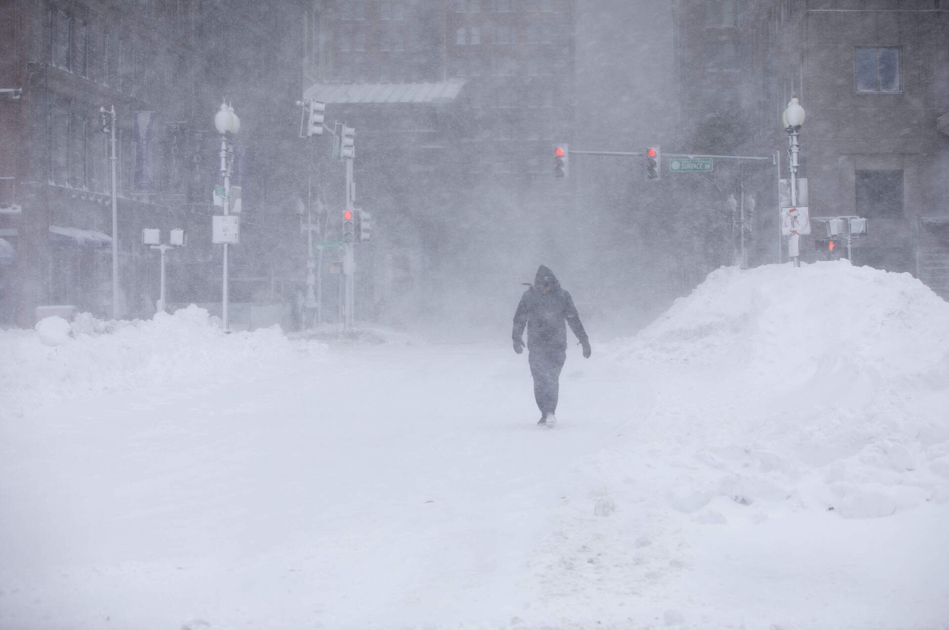 A pedestrian walks through wind and snow blowing along Atlantic Avenue in Boston. (Robin Lubbock/WBUR)