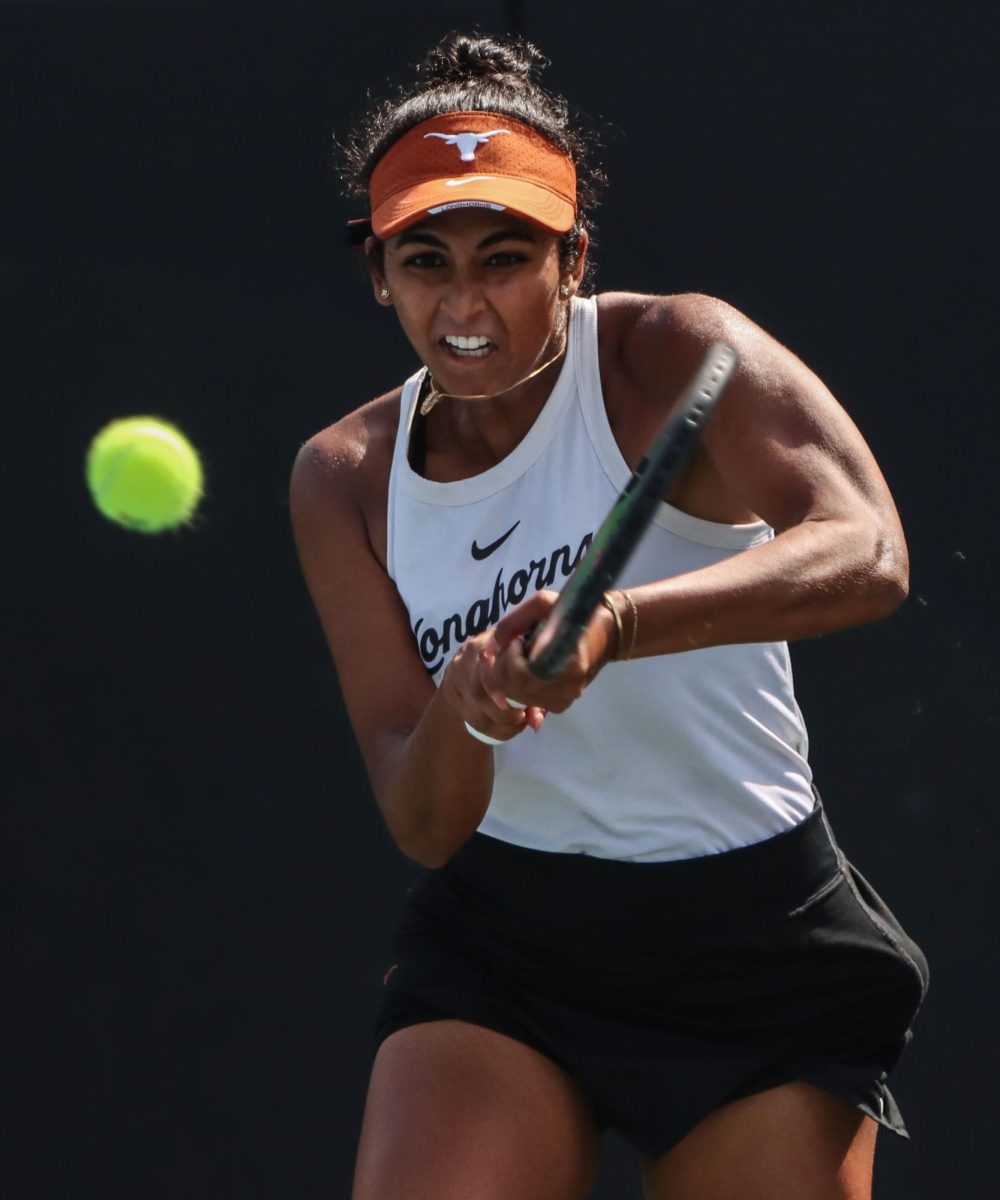 Senior Malaika Rapolu hits the ball during singles play against Ava Catanzarite of Oklahoma on March 3, 2024. Rapolu earned Texas' first win of the match with a 6-2, 6-2 victory over Catanzarite.