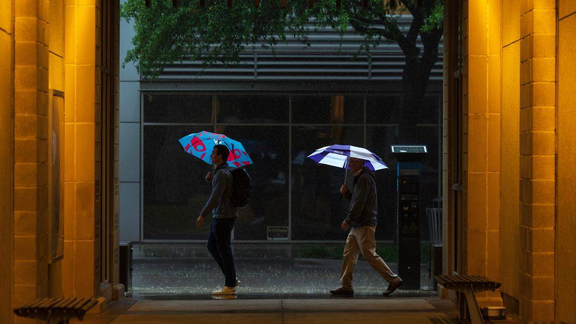 Pedestrian walk down Crockett Street during a thunderstorm on Wednesday, April 30, 2025, in Fort Worth