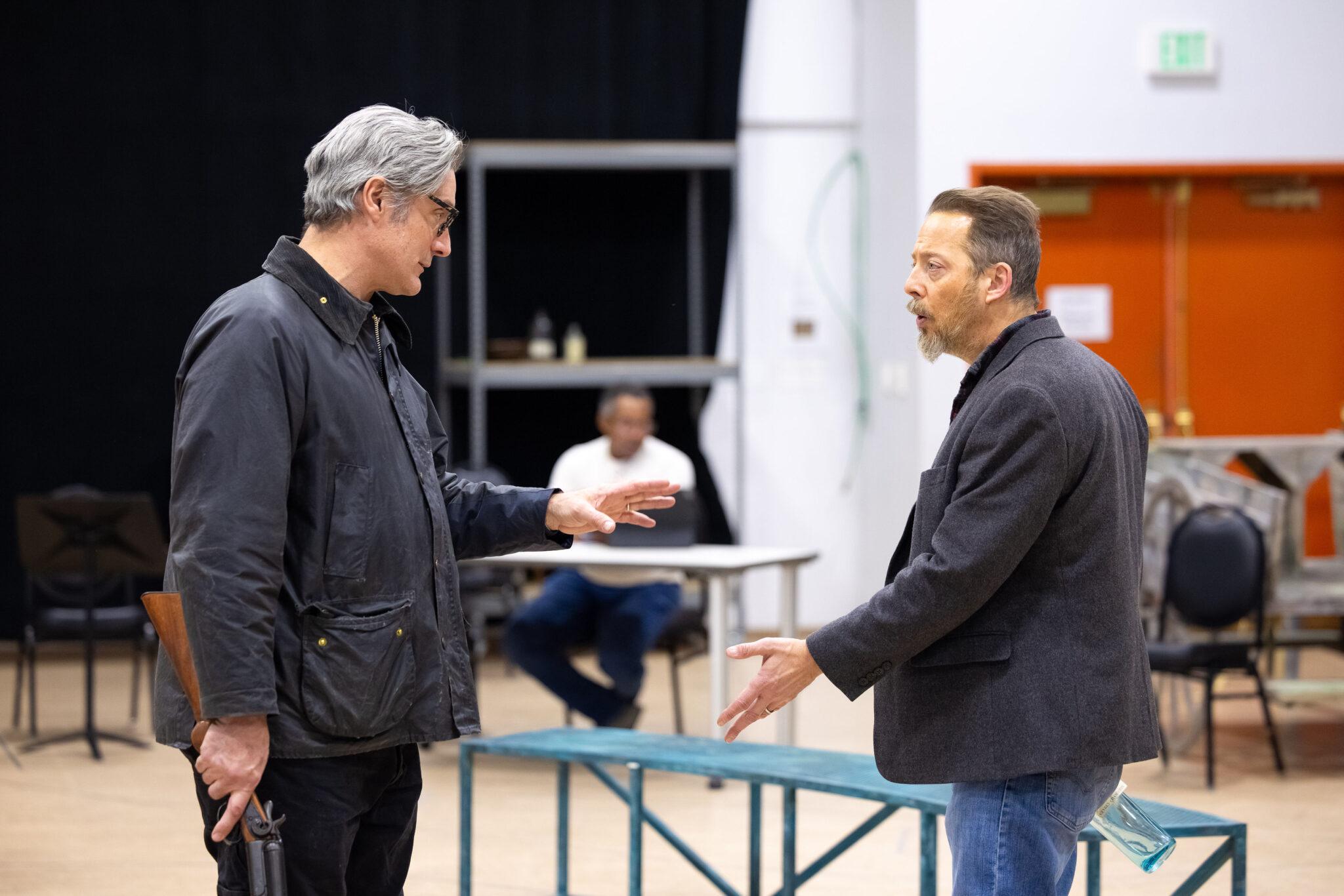 Two men stand opposite menacingly.