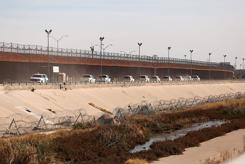 A convoy of U.S. Border Patrol vehicles drives the Mexico-U.S. border near El Paso, Texas.