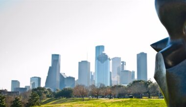 The downtown Houston skyline, with a cropped large bronze sculpture in the immediate foreground.