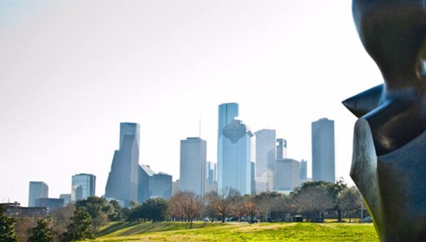 The downtown Houston skyline, with a cropped large bronze sculpture in the immediate foreground.