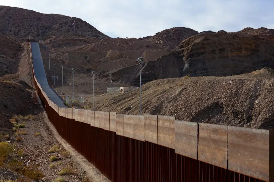 A section of the privately-funded border wall, seen from Ciudad Juárez, rises from the bank of Rio Grande toward Mount Cristo Rey in October 2020. Photo by Corrie Boudreaux/El Paso Matters