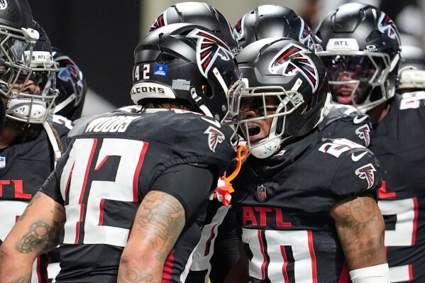 Atlanta Falcons cornerback Dee Alford (20) celebrates his interception with linebacker Josh Woods (42) in the second half of an NFL football game against the New Orleans Saints, Sunday, Jan. 4, 2026, in Atlanta. (AP Photo/Mike Stewart)