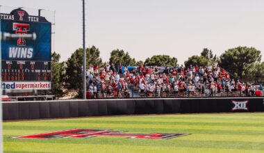 NiJaree Canady and Mihyia Davis holding the Big 12 tournament championship trophy