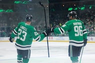 Dallas Stars defenseman Esa Lindell (23) cheers with Dallas Stars right wing Mikko Rantanen...