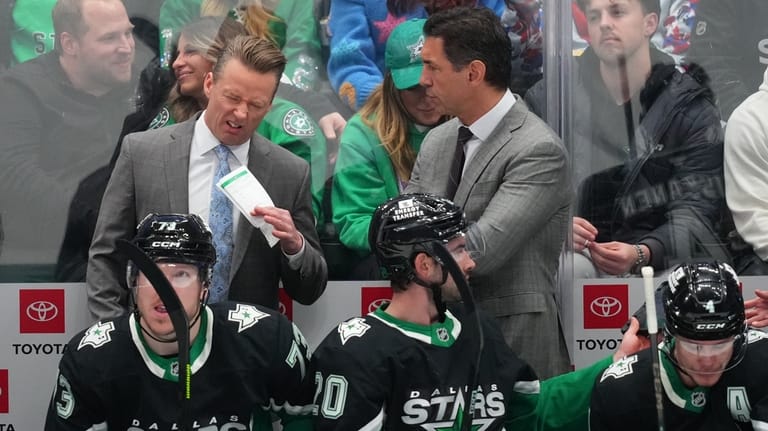 Dallas Stars head coach Glen Gulutzan, left, reacts while talking...