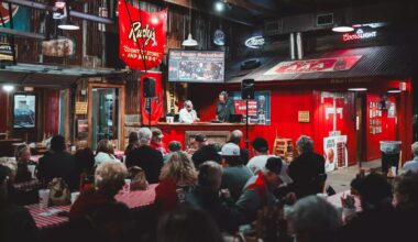 JT Toppin puts up a left-handed shot in the lane with two Kansas defenders attempting to stop him.