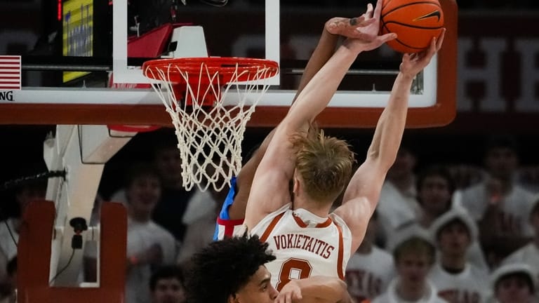 Texas center Matas Vokietaitis (8) is fouled by Mississippi forward...