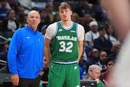 Dallas Mavericks head coach Jason Kidd, left, looks on from the sidelines with forward...