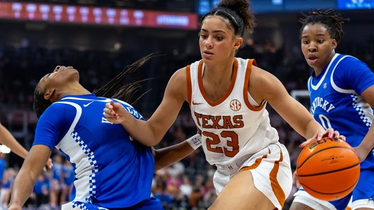 Texas guard Aaliyah Crump (23) drives to the basket between...