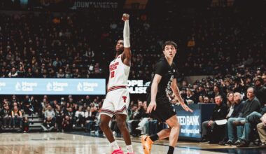 Christian Anderson launches a 3-pointer over the outstretched arm of a West Virginia defender.