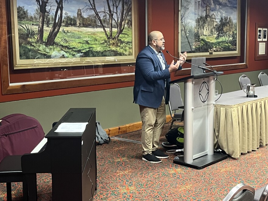 Texas trumpeter and educator Tito Carrillo speaks from the podium at TMEA