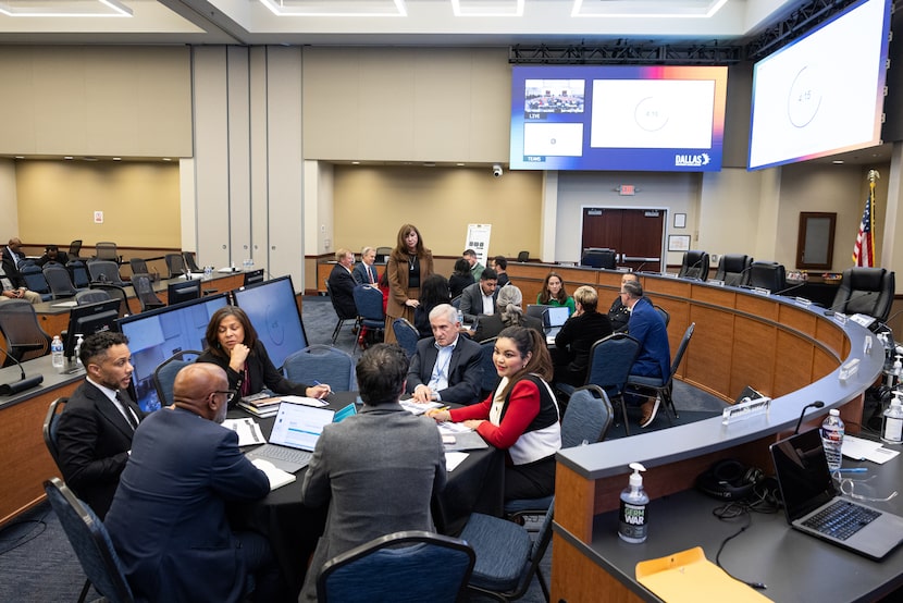 Dallas ISD Superintendent Stephanie Elizalde walks around tables filled with trustees and...