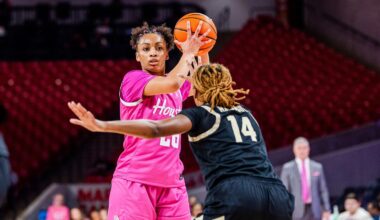 Briana Peguero, Jorynn Ross, Amirah Abdur-Rahim and Kierra Merchant talking in huddle