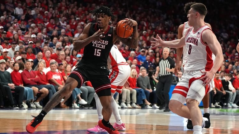 Texas Tech forward JT Toppin drives past Arizona forward Ivan...