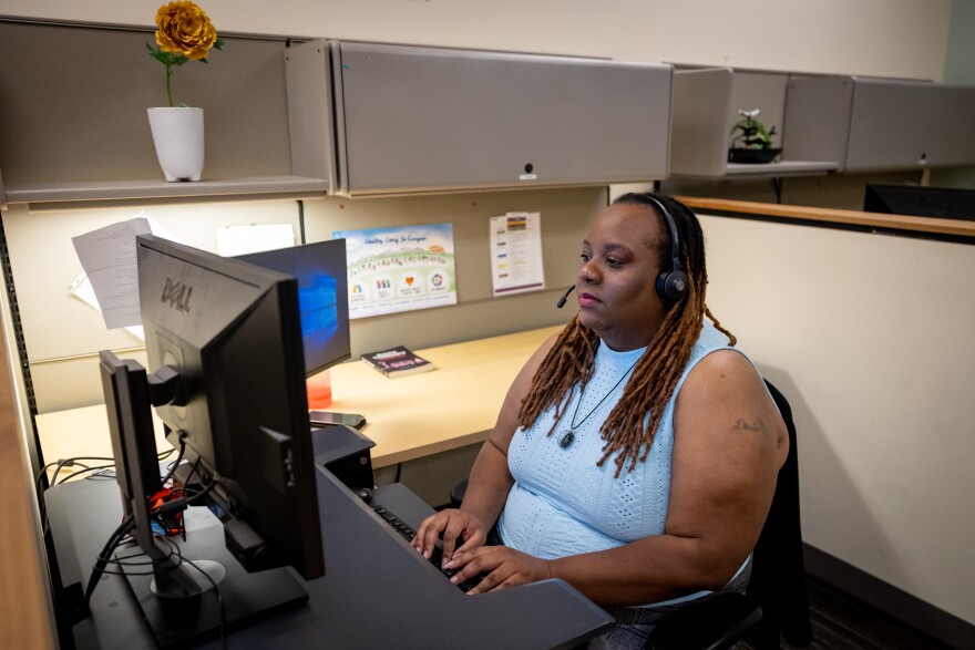 Yashi Duhon speaks with a 988 caller at Integral Care's Dove Springs Clinic in Austin, Texas in 2023.