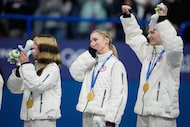 Alysa Liu, Amber Glenn, and Ilia Malinin of Team USA react after receiving their gold medals...