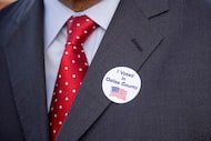 Criminal attorney Michael Todd wears a “I voted in Dallas County” sticker after voting at...