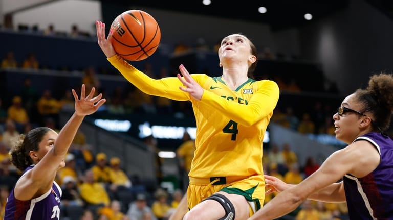 Baylor guard Jana Van Gytenbeek, left, shoots between TCU guard...