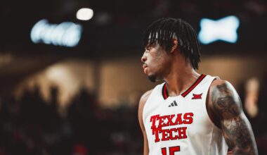 Christian Anderson dribbles through the lane with a Colorado defender attempting to guard him.