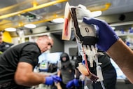 Fort Worth Fire Department Capt. Trent Robinson works to transfuse a gunshot victim with a...