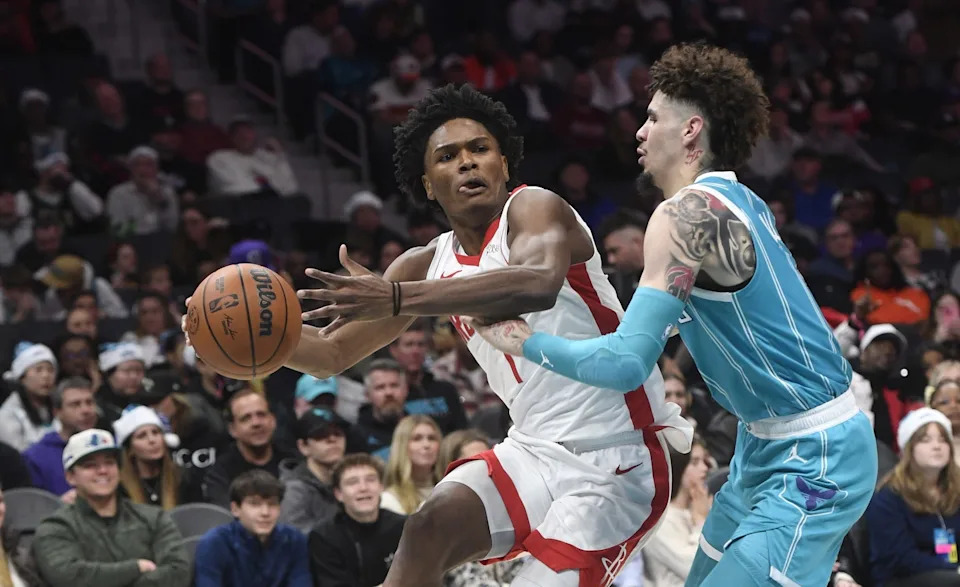 Dec 23, 2024; Charlotte, North Carolina, USA; Houston Rockets guard forward Amen Thompson (1) looks to pass through the defense of Charlotte Hornets LaMelo Ball (1) during the second half at the Spectrum Center. Mandatory Credit: Sam Sharpe-Imagn Images