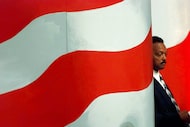 The Rev. Jesse Jackson waits while son Jesse Jackson Jr., introduces him to delegates at the...