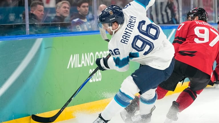 Finland's Mikko Rantanen (96) challenges with Canada's Connor McDavid (97)...