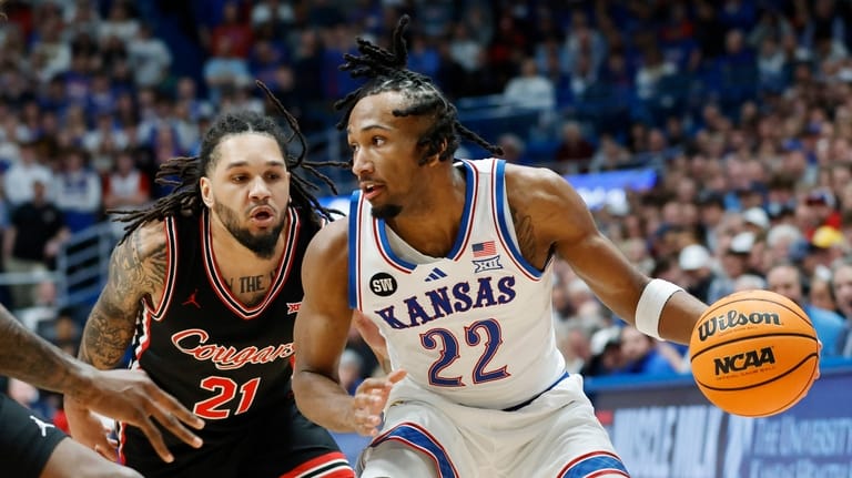 Kansas guard Darryn Peterson (22) attempts to get past Houston...